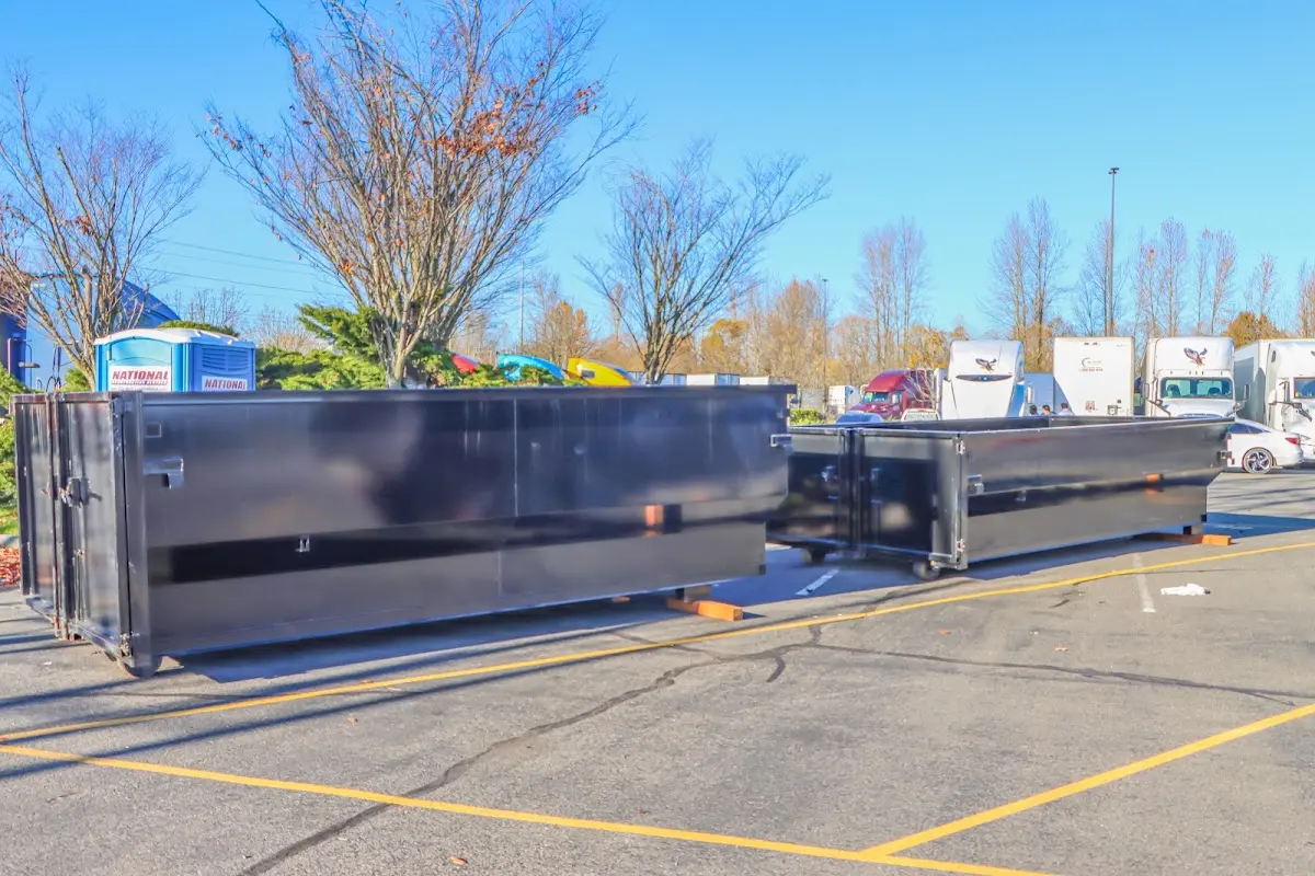 Professional dumpster rental service with roll-off container on residential driveway in Winterset